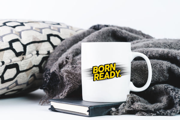 Lifestyle Image of Mug with design and cozy blanket/pillow background